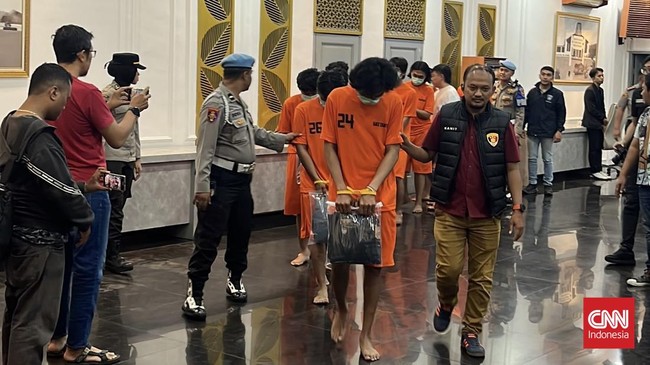Para tersangka berpakaian tahanan dikawal petugas