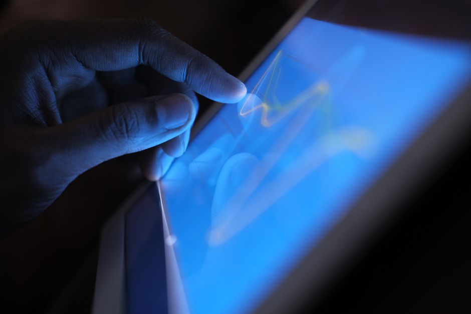 Tangan mengoperasikan tablet layar sentuh