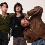 Grup musik Weird Genius tampil di atas panggung dengan pencahayaan konser