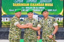 Serah terima jabatan Danrindam Iskandar Muda, tiga perwira TNI berbaret hijau berjabat tangan di depan spanduk acara