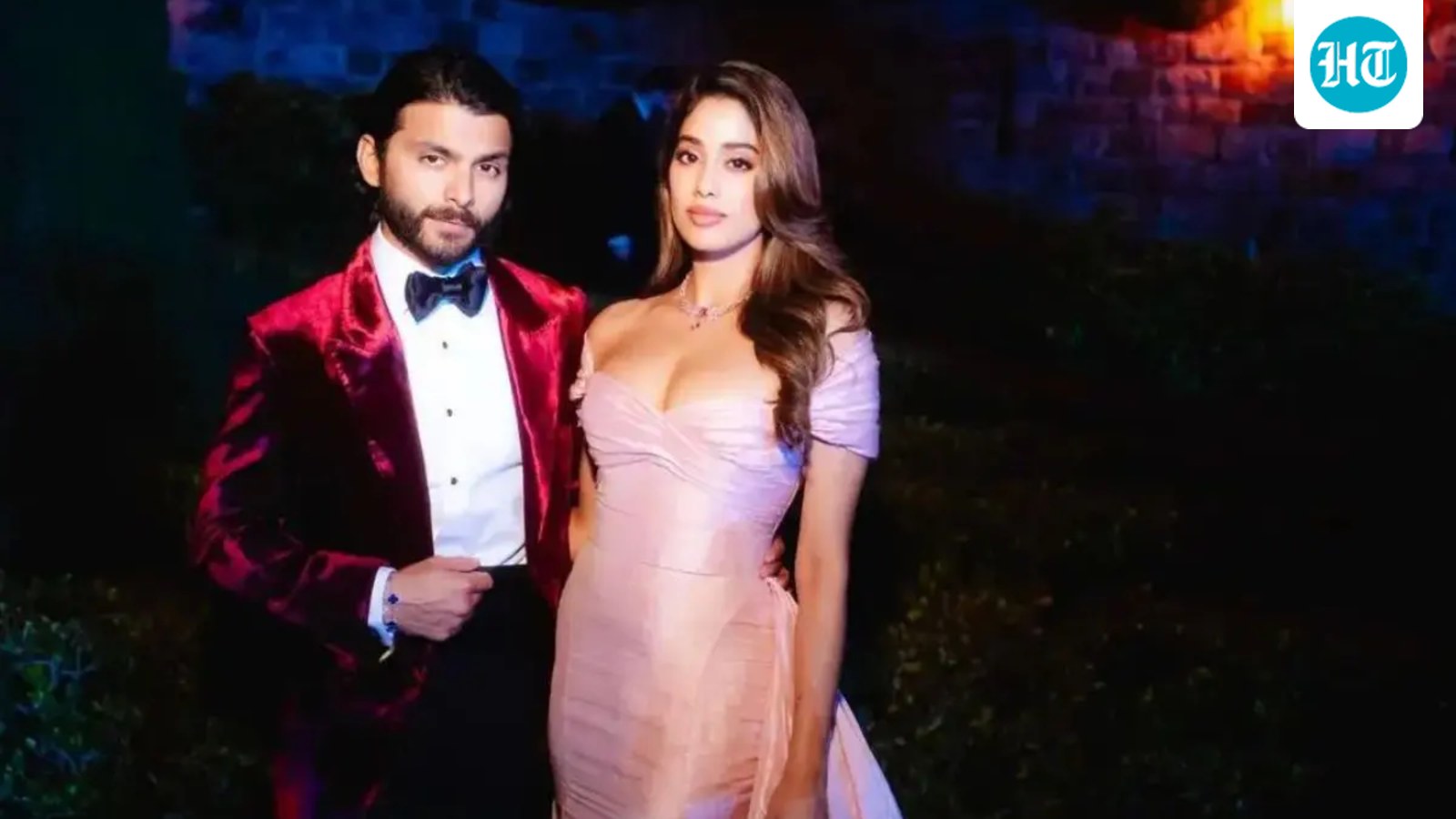Janhvi Kapoor dalam gaun merah muda berdiri berdampingan dengan Shikhar Pahariya berjas beludru merah di acara malam