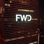 Logo FWD pada gedung bertingkat di malam hari