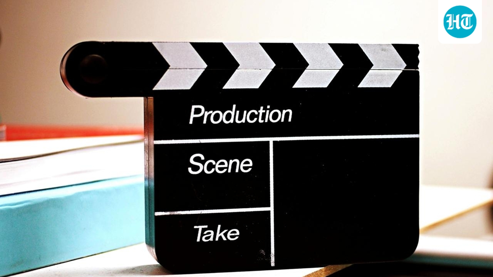 Papan clapperboard produksi film hitam putih di atas meja